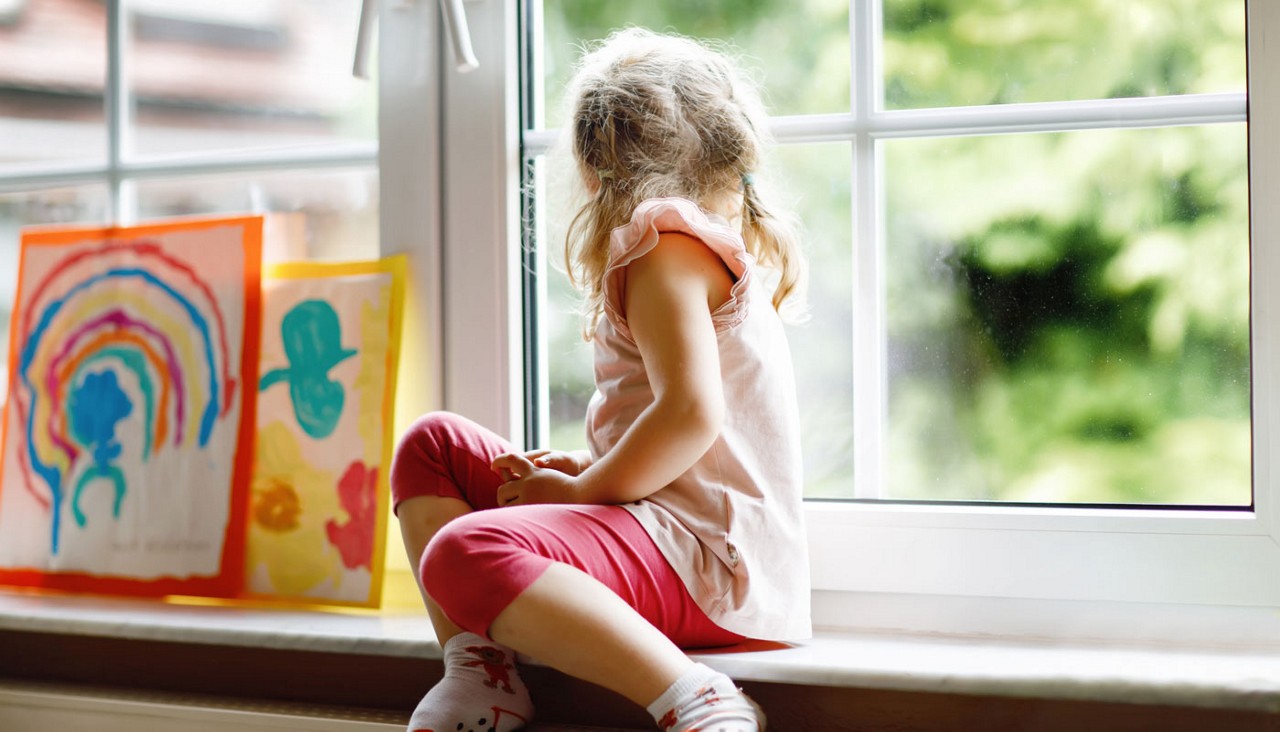 A child sitting turned back