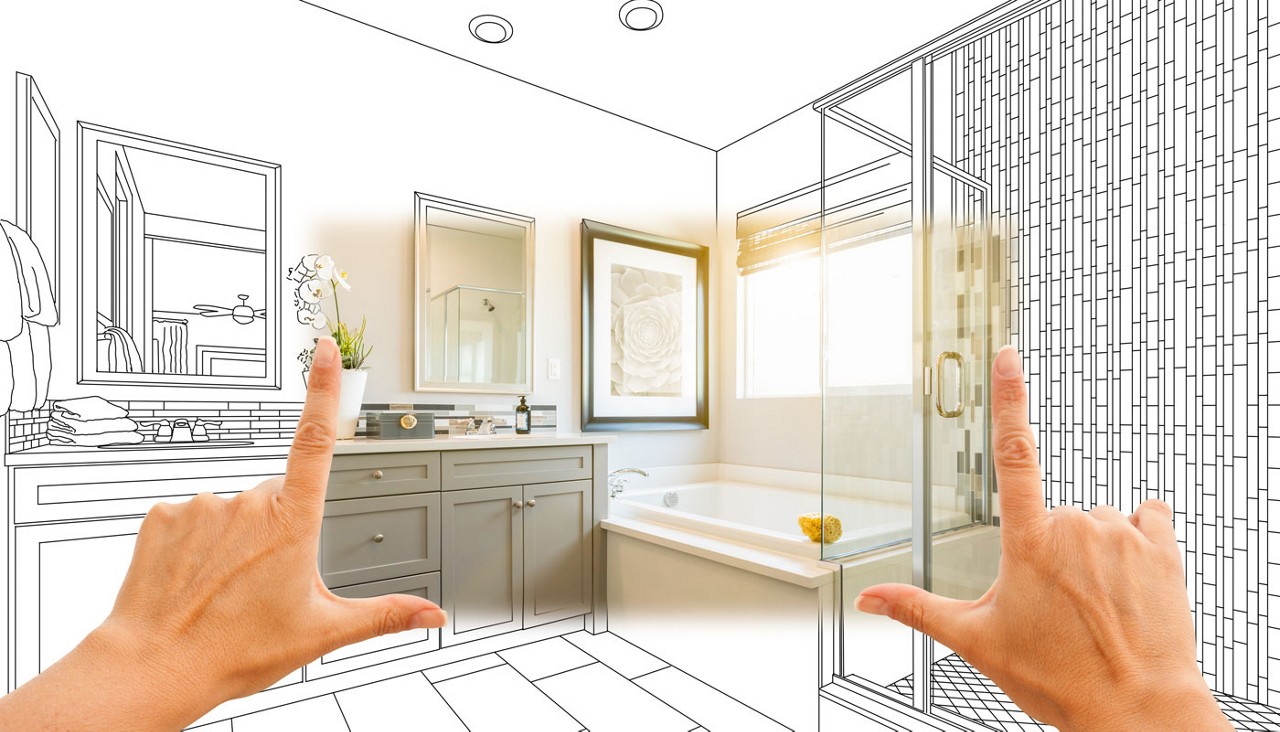 Hands frame a custom master bathroom photo section with a sketch drawing beyond them