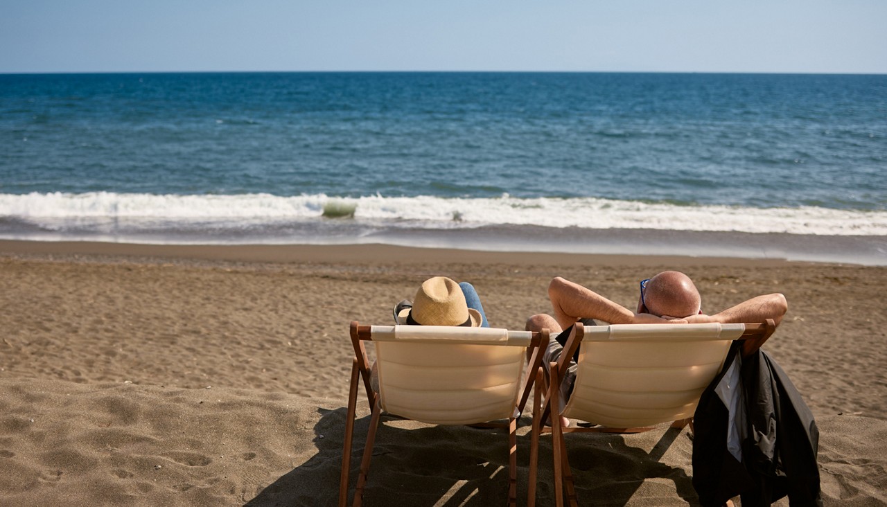 senior couple relaxing on a beach somewhere