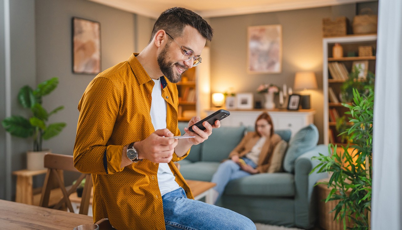 adult man at home shopping online use internet hold credit card e-banking online shop e-commerce