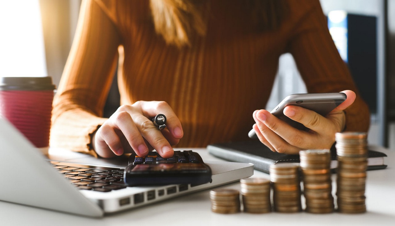 A lady with a calculator in hand