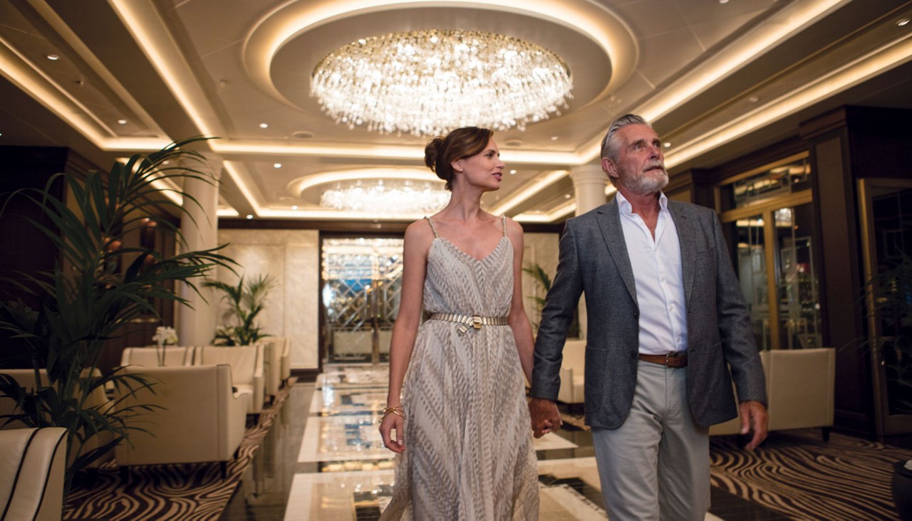 Couple walking through Atrium of cruise ship